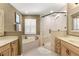 Bathroom featuring a soaking tub, glass shower, and dual vanities at 200 Se 145Th St, Summerfield, FL 34491