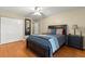 Bedroom with dark furniture, hard floors, and an organized closet at 200 Se 145Th St, Summerfield, FL 34491