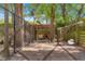 Fenced chicken coop with multiple chickens, covered area, and supplies, set on a gravel base at 200 Se 145Th St, Summerfield, FL 34491