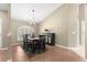 Bright dining room area featuring a large window, contemporary lighting fixture, and stylish furnishings at 200 Se 145Th St, Summerfield, FL 34491