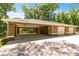 Detached three-car garage with a covered carport, providing ample parking and storage space for vehicles and equipment at 200 Se 145Th St, Summerfield, FL 34491