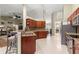 Open-concept kitchen with granite countertops, stainless steel appliances, a breakfast bar, and seamless flow to the living areas at 200 Se 145Th St, Summerfield, FL 34491