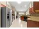 Modern kitchen featuring stainless steel appliances, granite countertops, and ample cabinet space for storage and meal preparation at 200 Se 145Th St, Summerfield, FL 34491