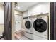 Laundry room with modern washer and dryer and storage cabinets at 200 Se 145Th St, Summerfield, FL 34491