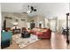 Spacious living room with high ceilings, a large sectional sofa, and stylish decor, perfect for entertaining guests at 200 Se 145Th St, Summerfield, FL 34491