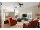 Cozy living room featuring large windows, a ceiling fan, comfortable seating, and access to the outdoor pool area at 200 Se 145Th St, Summerfield, FL 34491
