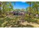 Screened-in pool area surrounded by trees and landscaping, providing a private backyard oasis at 200 Se 145Th St, Summerfield, FL 34491