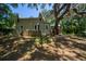 Lovely outdoor shot with a light green house, large trees, and green grass at 20549 9Th St, Mc Intosh, FL 32664