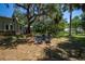 Backyard featuring an outdoor seating area and lush green trees near the home at 20549 9Th St, Mc Intosh, FL 32664