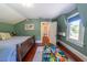 Bedroom featuring a wooden bed frame, hardwood floors, play area, and window with natural light at 20549 9Th St, Mc Intosh, FL 32664
