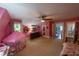 Spacious bedroom boasting a unique layout, large windows, plush carpeting, and an attached bathroom at 20549 9Th St, Mc Intosh, FL 32664