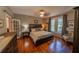 Bedroom with a ceiling fan, bed, dresser, and windows offering natural lighting at 20549 9Th St, Mc Intosh, FL 32664