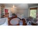 Bedroom featuring a crib, hardwood floors, window, storage space and changing table at 20549 9Th St, Mc Intosh, FL 32664