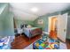 Charming bedroom featuring a wooden bed frame, hardwood floors, and a colorful toy area at 20549 9Th St, Mc Intosh, FL 32664