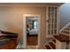 View of a bedroom with a bed, wood floors, and an open door, through the entryway at 20549 9Th St, Mc Intosh, FL 32664