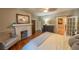 Bedroom featuring a bed, fireplace, wooden floors and furniture with plenty of natural lighting at 20549 9Th St, Mc Intosh, FL 32664