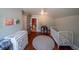 Bedroom featuring a crib, hardwood floors, changing table and storage space at 20549 9Th St, Mc Intosh, FL 32664