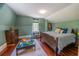 Bedroom featuring a wooden bed frame and green walls at 20549 9Th St, Mc Intosh, FL 32664