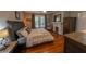 Bedroom featuring a bed, fireplace, hardwood floors, dresser, and natural lighting at 20549 9Th St, Mc Intosh, FL 32664