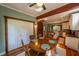 Dining room showing hardwood floors, exposed beams and open concept to kitchen at 20549 9Th St, Mc Intosh, FL 32664