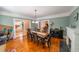 Inviting dining room with hardwood floors, fireplace, and open access to the kitchen at 20549 9Th St, Mc Intosh, FL 32664