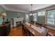 Cozy dining room with hardwood floors, a fireplace, and a view of the outdoor greenery at 20549 9Th St, Mc Intosh, FL 32664
