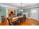 Open dining room with hardwood floors, fireplace, and seamless connection to living spaces at 20549 9Th St, Mc Intosh, FL 32664
