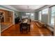 Spacious dining room with hardwood floors, fireplace, and natural light from large windows at 20549 9Th St, Mc Intosh, FL 32664
