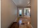 Tiled entryway with a glass front door and view to a half-bathroom at 20549 9Th St, Mc Intosh, FL 32664