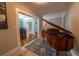 Elegant entryway boasting a grand piano, hardwood flooring and view into the dining room at 20549 9Th St, Mc Intosh, FL 32664