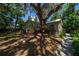 Charming home featuring a metal roof, quaint windows, a wooden porch, and a majestic tree at 20549 9Th St, Mc Intosh, FL 32664