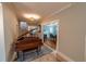 Inviting foyer featuring a grand piano, access to the living room, dining area, and staircase at 20549 9Th St, Mc Intosh, FL 32664