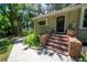 Charming front entrance with brick steps, lush landscaping, and a welcoming front door at 20549 9Th St, Mc Intosh, FL 32664