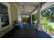 Spacious front porch with comfortable seating and views of the surrounding greenery and side yard at 20549 9Th St, Mc Intosh, FL 32664