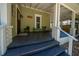 Inviting front porch with seating area, columns, and steps leading up to the entrance door at 20549 9Th St, Mc Intosh, FL 32664