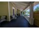 Extended front porch with multiple seating areas offering ample space for relaxation and socializing at 20549 9Th St, Mc Intosh, FL 32664