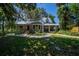 Charming home featuring a metal roof, landscaped yard, and inviting walkway at 20549 9Th St, Mc Intosh, FL 32664