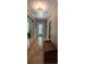 Inviting hallway with tile flooring, a decorative ceiling light, and access to various rooms at 20549 9Th St, Mc Intosh, FL 32664