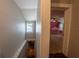 Hallway view showcasing wood and tile flooring, connecting to a charming bedroom at 20549 9Th St, Mc Intosh, FL 32664