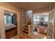 View of the stairwell and front room from the hall at 20549 9Th St, Mc Intosh, FL 32664
