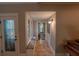 Bright hallway with tiled floors, window seat, and decorative glass door offering a welcoming entrance to the home at 20549 9Th St, Mc Intosh, FL 32664