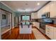 Bright kitchen with white cabinets, stainless steel appliances, and hardwood flooring at 20549 9Th St, Mc Intosh, FL 32664