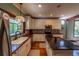 Modern kitchen with white cabinetry, stainless appliances, and hardwood floors at 20549 9Th St, Mc Intosh, FL 32664
