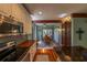 Kitchen with hardwood floors, white cabinets, stainless steel appliances, and dining area at 20549 9Th St, Mc Intosh, FL 32664