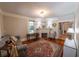Cozy living room with fireplace, area rug, window and hardwood floors at 20549 9Th St, Mc Intosh, FL 32664