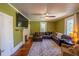 Living room showcasing a TV, fireplace, natural lighting, leather sofa and hardwood floors at 20549 9Th St, Mc Intosh, FL 32664