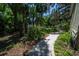 Peaceful side yard featuring a walkway, greenery, and a glimpse of the surrounding landscape at 20549 9Th St, Mc Intosh, FL 32664