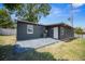 Back of house featuring updated siding, newer AC unit, and rear patio at 219 Marion Oaks Ln, Ocala, FL 34473