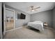 Relaxing bedroom with neutral walls, tile flooring, and an adjacent hallway at 219 Marion Oaks Ln, Ocala, FL 34473