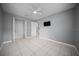 Bedroom with tile floor, ceiling fan and mounted television at 219 Marion Oaks Ln, Ocala, FL 34473